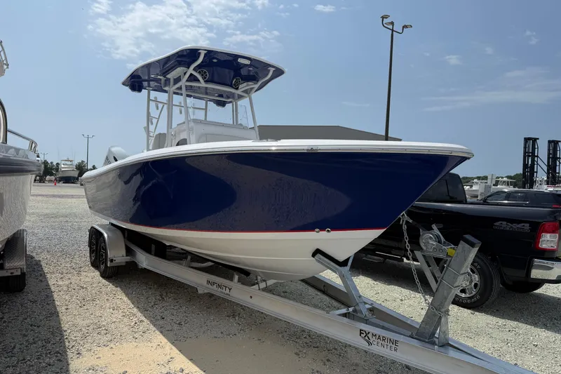 The Image of 2026 Clearwater 2800 Center Console boat on trailer, parked outdoors under a clear sky. - 0