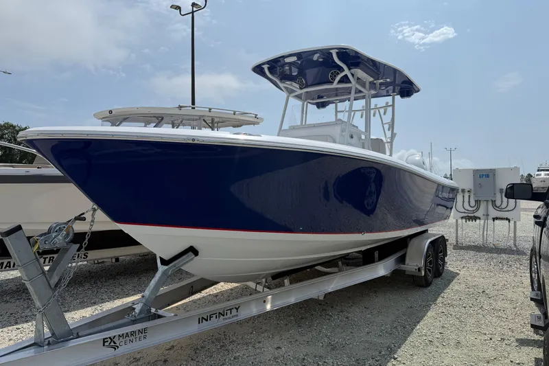 Slide: The Image of 2026 Clearwater 2800 Center Console boat on trailer, displayed outdoors under clear sky. - 4