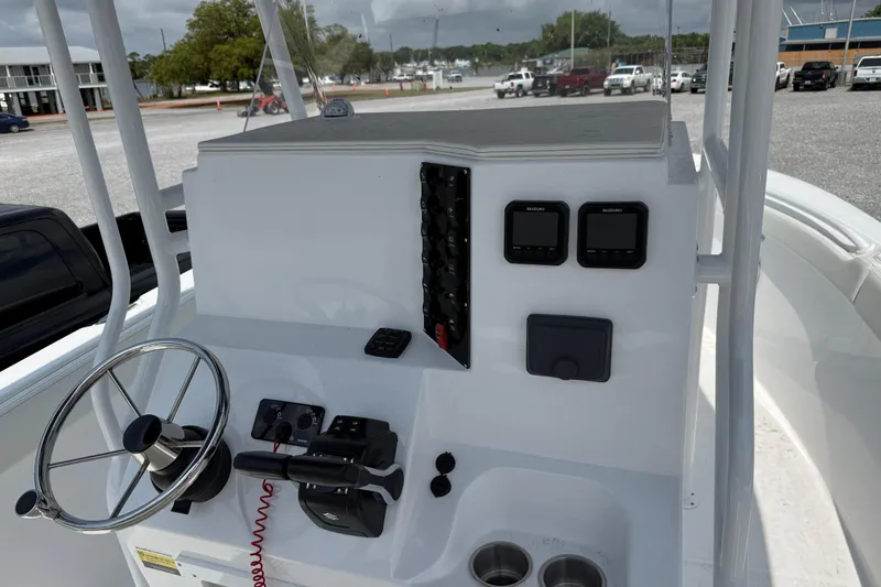 Slide: The Image of Clearwater 2800 Center Console 2026 boat dashboard with steering wheel and controls. - 7