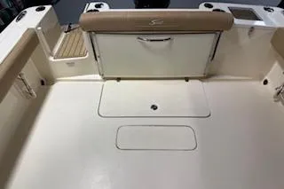 Slide: The Image of 2021 Scout 215 Dorado boat interior with beige seating and storage compartments. - 12