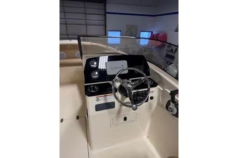 Slide: The Image of 2021 Scout 215 Dorado boat interior with steering wheel and dashboard controls. - 16