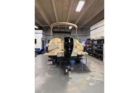 Slide: The Image of 2021 Scout 215 Dorado boat in a garage, rear view with outboard motor. - 4