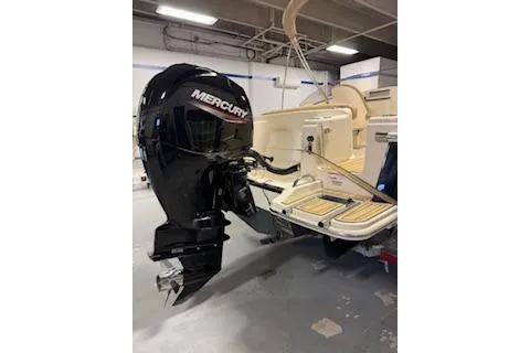 Slide: The Image of 2021 Scout 215 Dorado boat with Mercury outboard motor in a garage. - 5