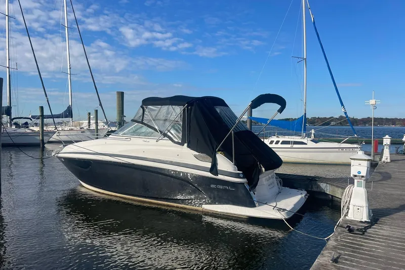 The Image of 2013 Regal 28 Express boat docked at marina under clear blue sky. - 0