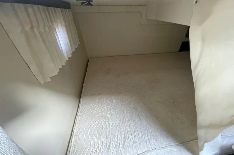 Slide: The Image of Interior cabin of 2013 Regal 28 Express boat with bed and curtains. - 11