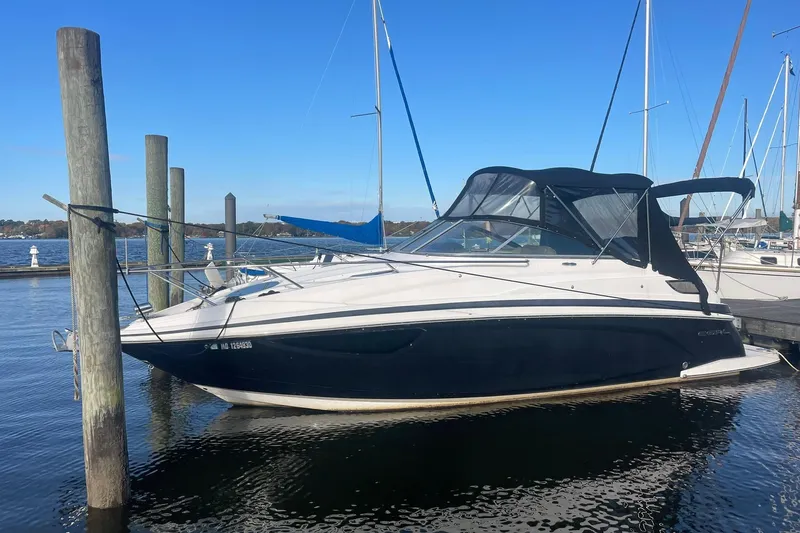 Slide: The Image of 2013 Regal 28 Express boat docked at marina under clear blue sky. - 2