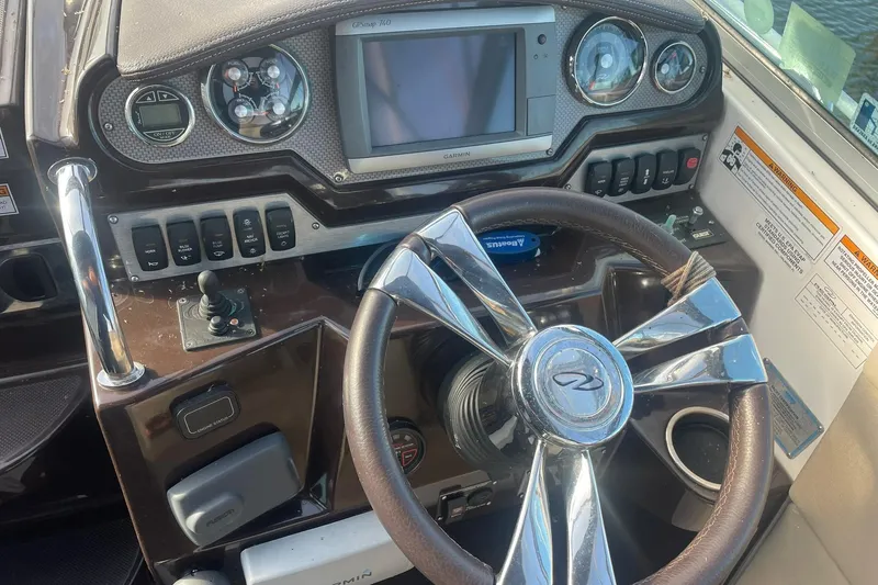 Slide: The Image of Dashboard of a 2013 Regal 28 Express boat with steering wheel and controls. - 5