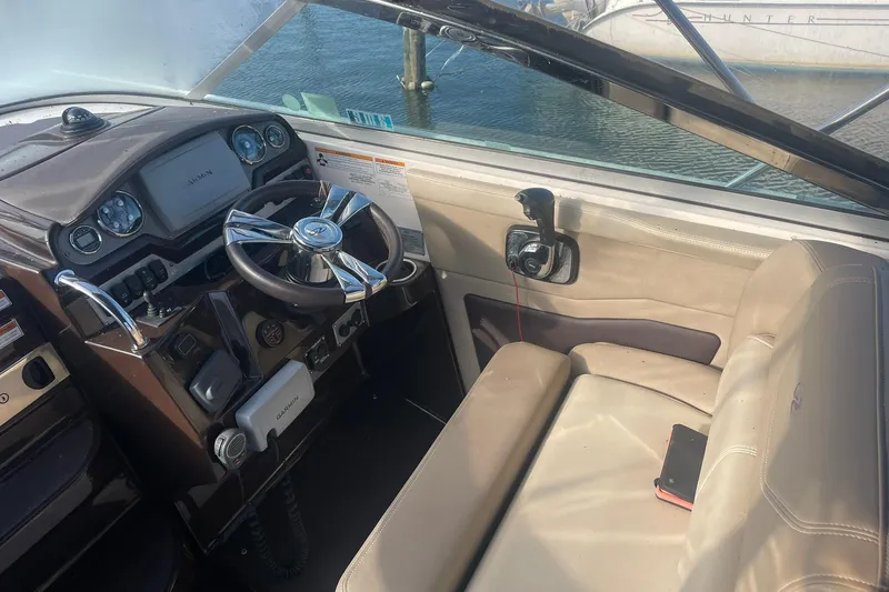 Slide: The Image of Cockpit of 2013 Regal 28 Express boat with steering wheel and navigation equipment. - 6
