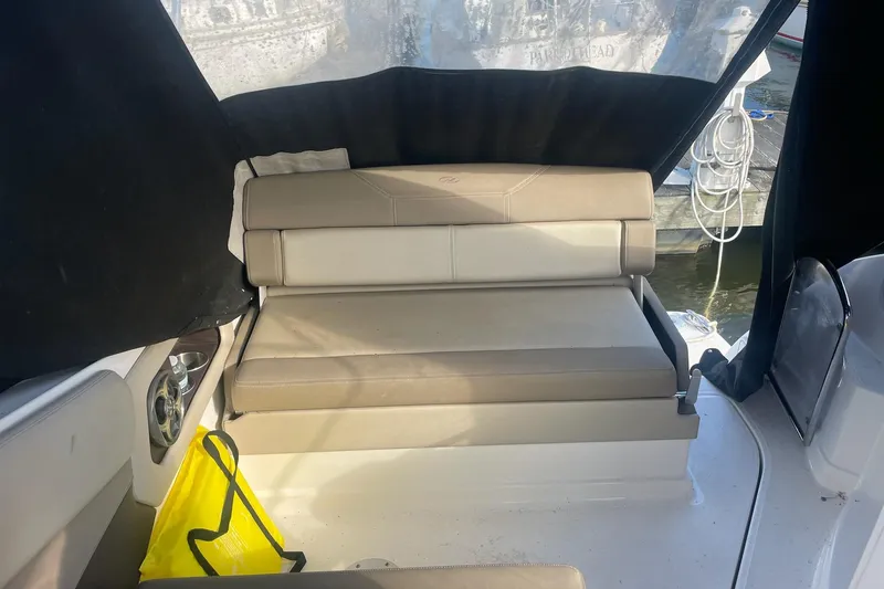 Slide: The Image of Interior seating of a 2013 Regal 28 Express boat with beige upholstery. - 7