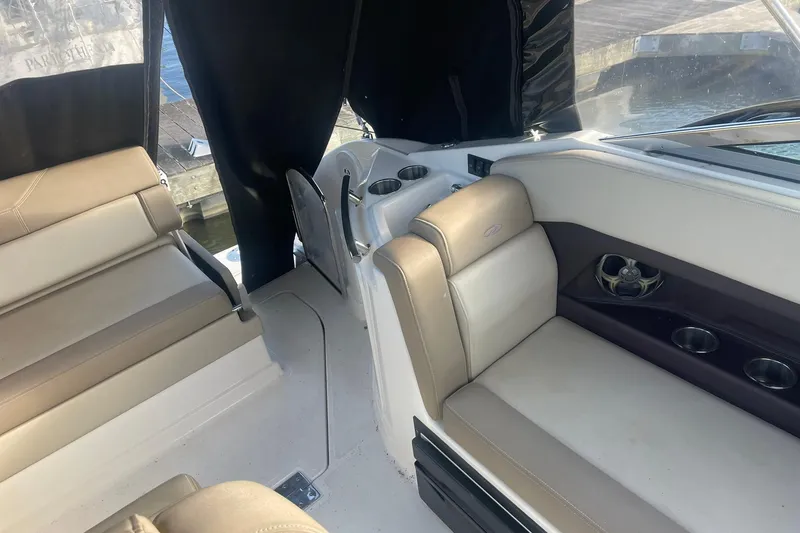 Slide: The Image of Interior of a 2013 Regal 28 Express boat with beige seating and cup holders. - 8