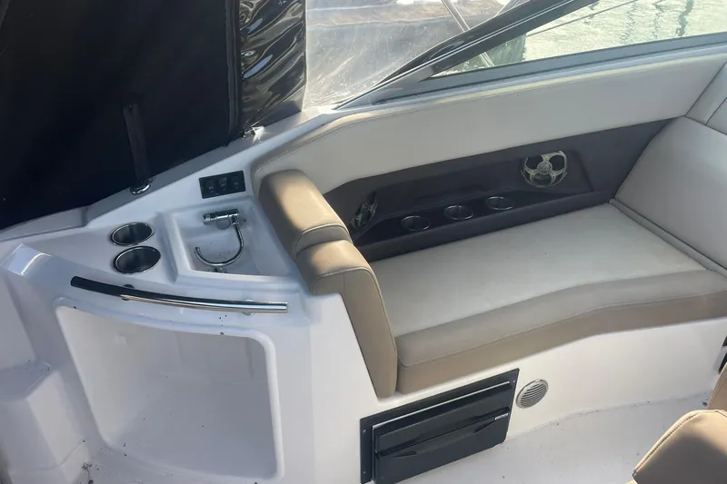 Slide: The Image of Interior seating area of a 2013 Regal 28 Express boat with cup holders. - 9