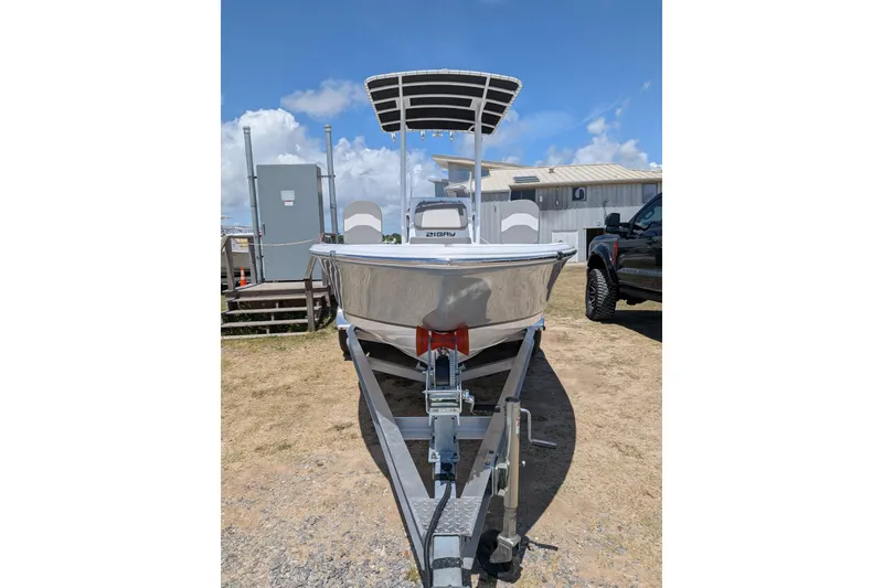 Slide: The Image of 2026 Clearwater 21 Bay boat on trailer under clear blue sky. - 3