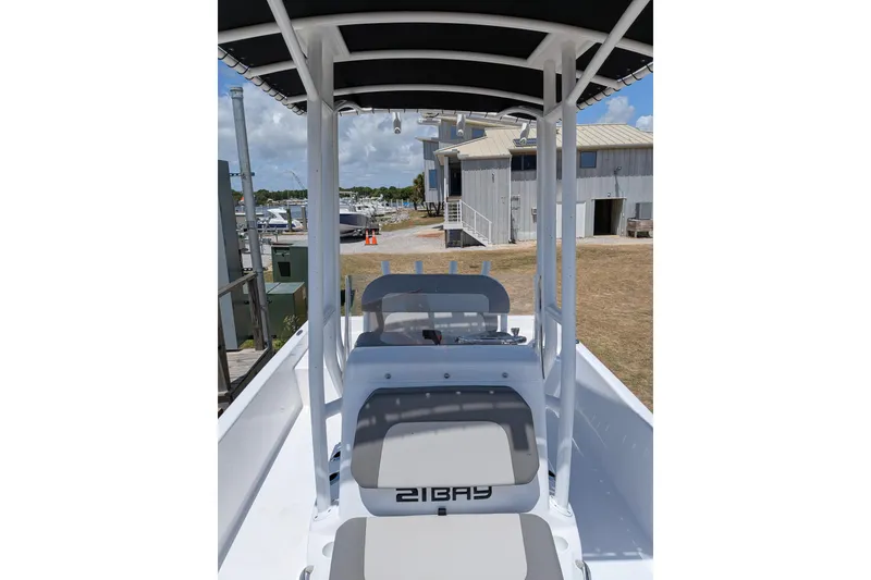 Slide: The Image of 2026 Clearwater 21 Bay boat interior with seating and console, dockside view. - 6