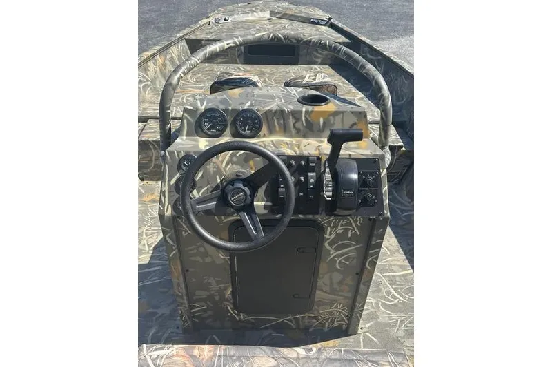 Slide: The Image of 2026 War Eagle 2170 Blackhawk boat dashboard with camo design and steering wheel. - 10