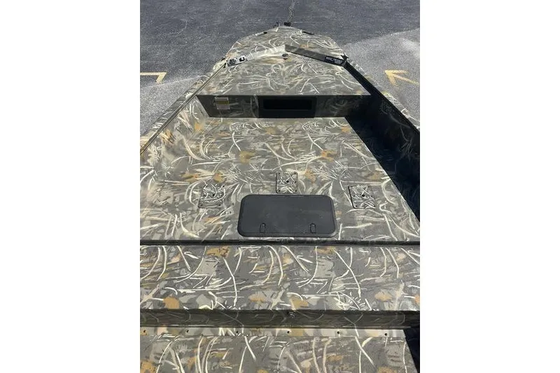 Slide: The Image of Camouflage-patterned 2026 War Eagle 2170 Blackhawk boat deck, featuring storage compartments. - 5