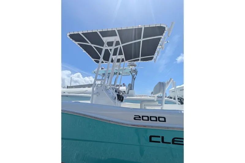 Slide: The Image of Clearwater 2000 Center Console boat, 2026 model, with T-top under a clear blue sky. - 2