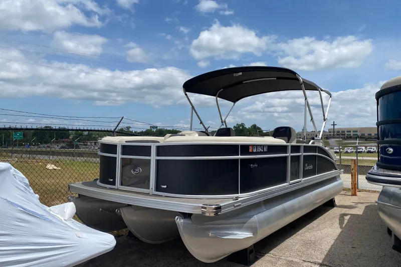 The Image of 2023 Barletta ARIA 22UC pontoon boat with canopy, parked outdoors under a cloudy sky. - 0