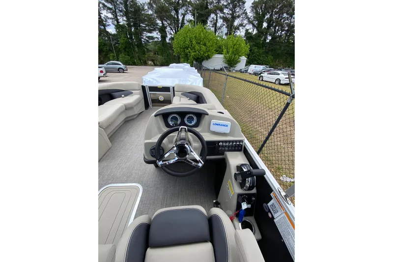 Slide: The Image of 2023 Barletta ARIA 22UC boat interior with steering wheel and dashboard controls. - 5