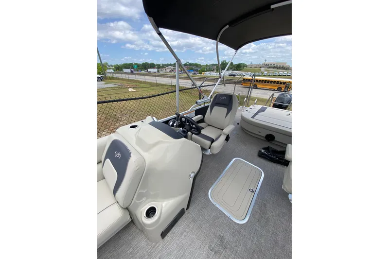 Slide: The Image of 2023 Barletta ARIA 22UC boat interior with helm, seating, and storage compartment. - 6