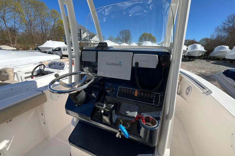 Slide: The Image of 2017 Pursuit C 238 Center Console boat with Garmin navigation system and steering wheel. - 15