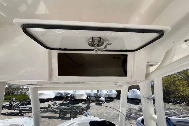 Slide: The Image of 2017 Pursuit C 238 Center Console boat with open storage compartment. - 18