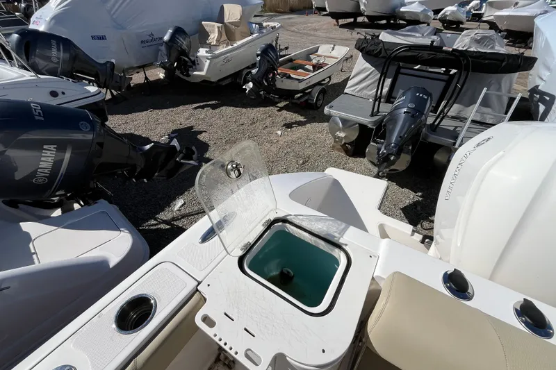 Slide: The Image of 2017 Pursuit C 238 Center Console boat with Yamaha outboard engines in a storage yard. - 19