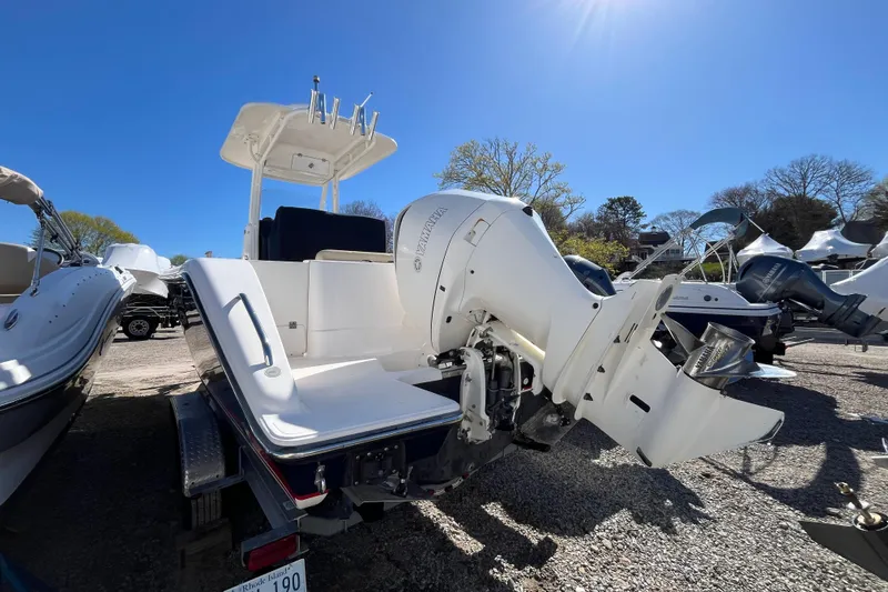 Slide: The Image of 2017 Pursuit C 238 Center Console boat with Yamaha outboard motor, parked outdoors under clear blue sky. - 4