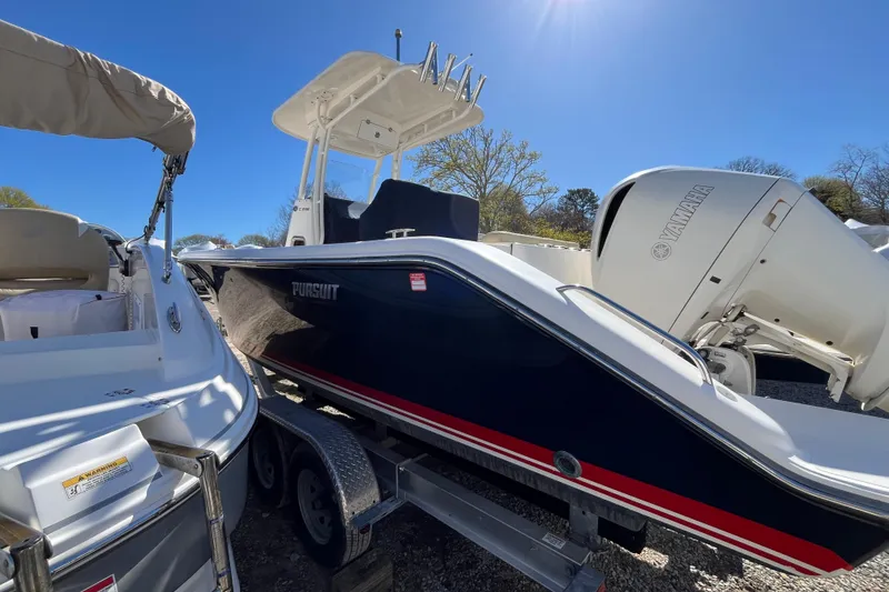 Slide: The Image of 2017 Pursuit C 238 Center Console boat on trailer with Yamaha engine under clear sky. - 5