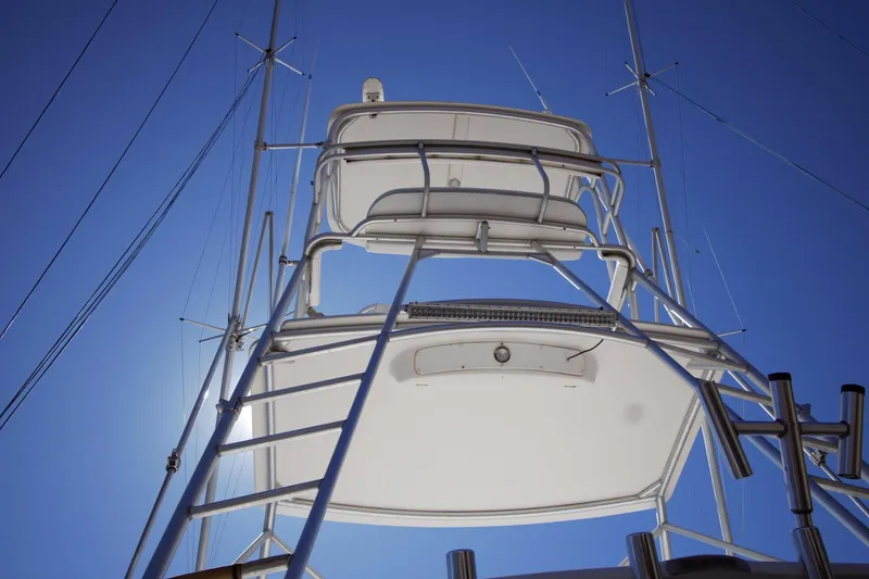 Slide: The Image of 2004 Cabo 40 Express yacht tower against clear blue sky. - 11