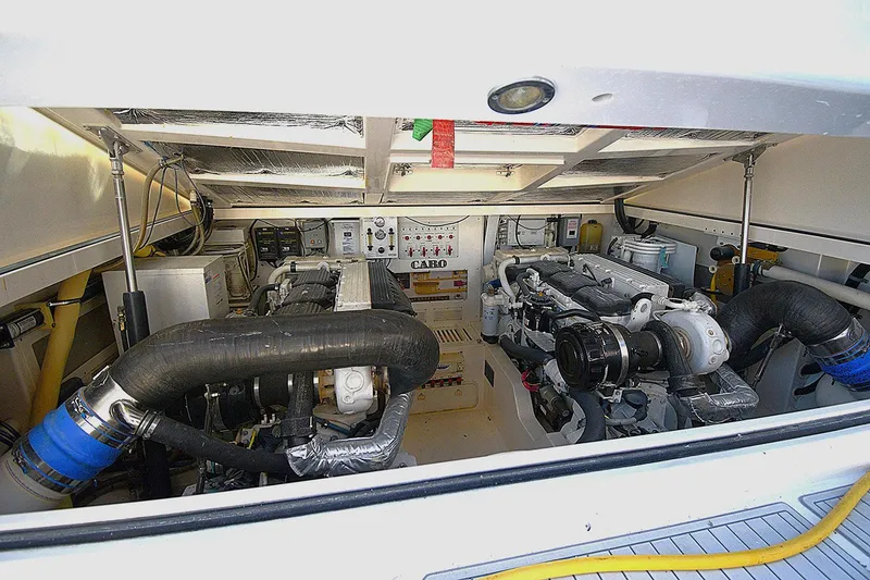 Slide: The Image of Engine room of a 2004 Cabo 40 Express boat, showcasing dual engines and mechanical components. - 15
