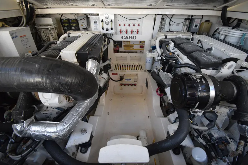 Slide: The Image of Engine room of a 2004 Cabo 40 Express boat, showcasing dual engines and control systems. - 16