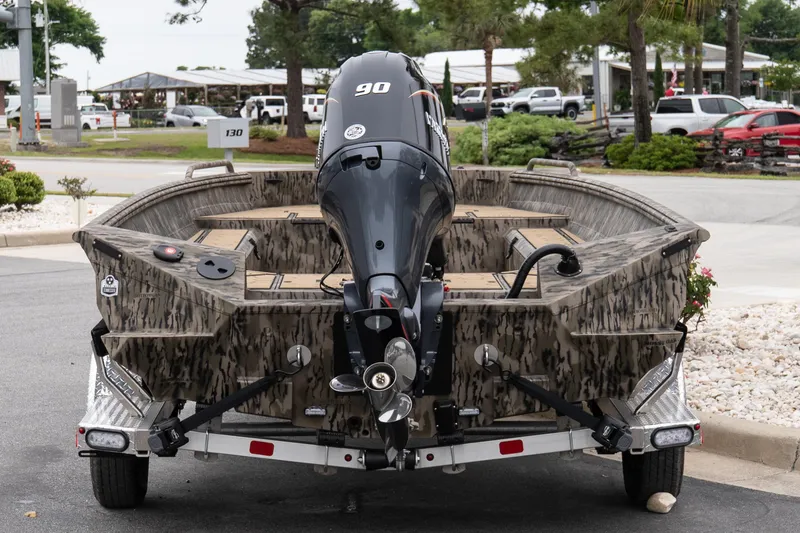 Slide: The Image of 2026 Excel 203 Bay Pro Elite boat with camouflage design and powerful outboard motor. - 4