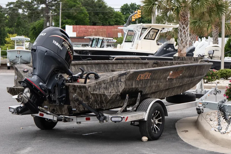 Slide: The Image of 2026 Excel 203 Bay Pro Elite boat with Yamaha motor on trailer, parked outdoors. - 5