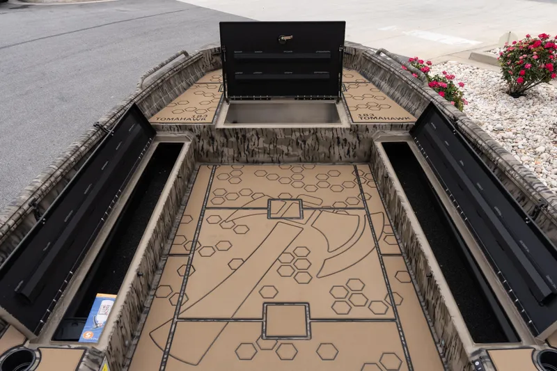 Slide: The Image of 2026 Excel 203 Bay Pro Elite boat interior with storage compartments and patterned flooring. - 7