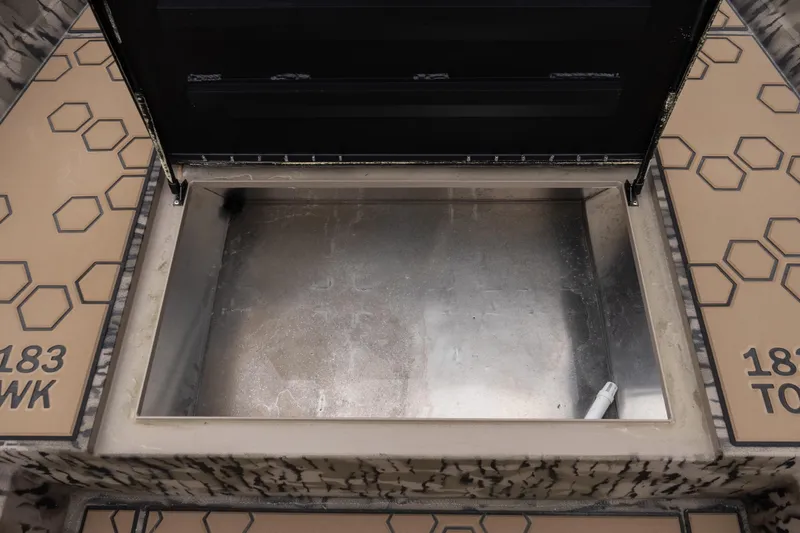 Slide: The Image of Open storage compartment of 2026 Excel 203 Bay Pro Elite boat, featuring hexagonal pattern design. - 8