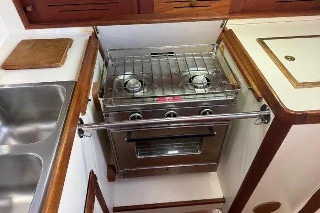 Slide: The Image of 1985 Cape Dory Cutter yacht kitchen with stainless steel stove and sink. - 12