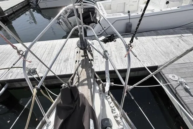 Slide: The Image of 1985 Cape Dory Cutter sailboat docked at a marina, showing deck and rigging details. - 16