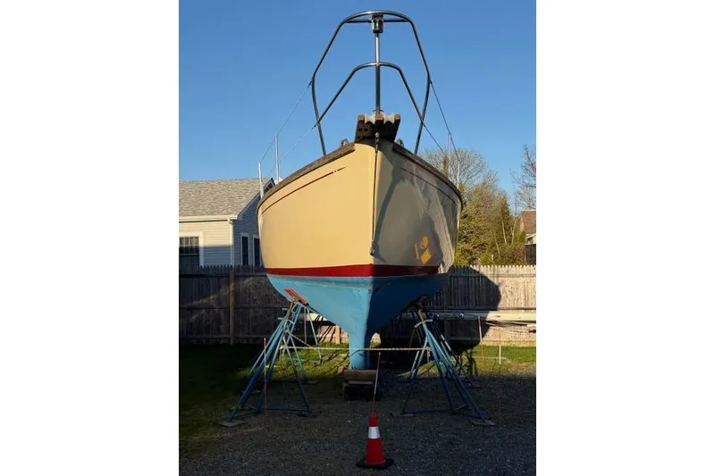 Slide: The Image of 1985 Cape Dory Cutter sailboat on stands, displayed outdoors. - 21