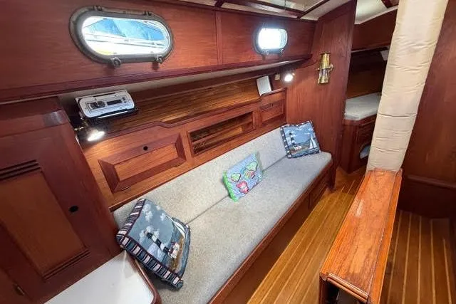 Slide: The Image of Interior of a 1985 Cape Dory Cutter sailboat with wooden finish and cozy seating. - 4