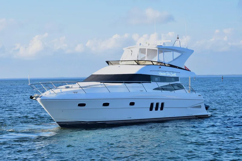 Slide: The Image of Luxury 2010 Neptunus 58 yacht cruising on open water. - 1