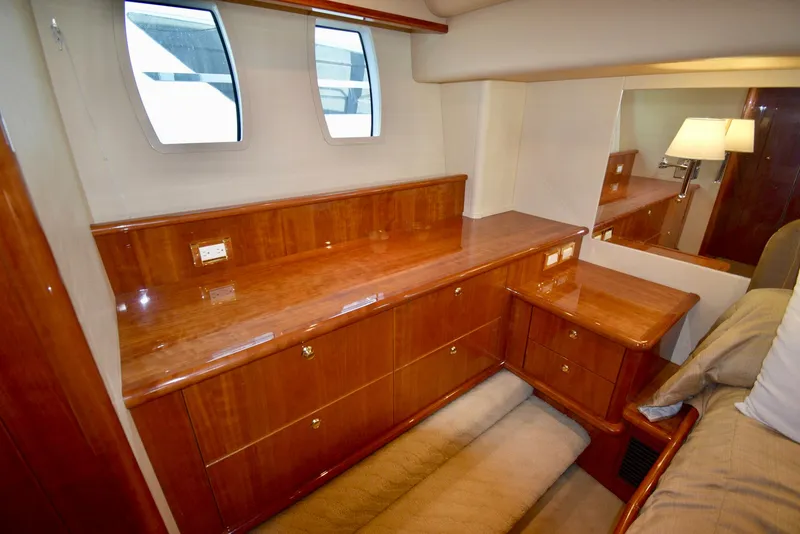 Slide: The Image of Luxurious wooden interior of 2010 Neptunus 58 yacht cabin with drawers and windows. - 13