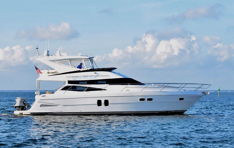 Slide: The Image of Luxury 2010 Neptunus 58 yacht cruising on open water under a clear sky. - 2
