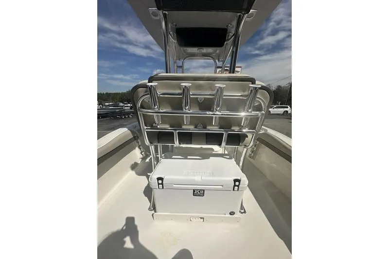 Slide: The Image of 2026 Key West 219 FS boat interior with rod holders and cooler under a clear sky. - 13
