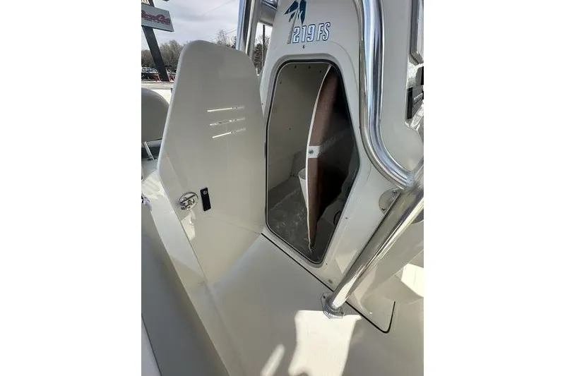 Slide: The Image of 2026 Key West 219 FS boat interior with open storage compartment. - 14