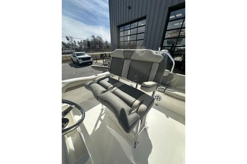 Slide: The Image of 2026 Key West 219 FS boat interior with cushioned seating and steering wheel. - 6