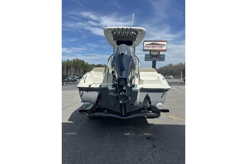 Slide: The Image of 2026 Key West 219 FS boat rear view in parking lot under blue sky. - 7