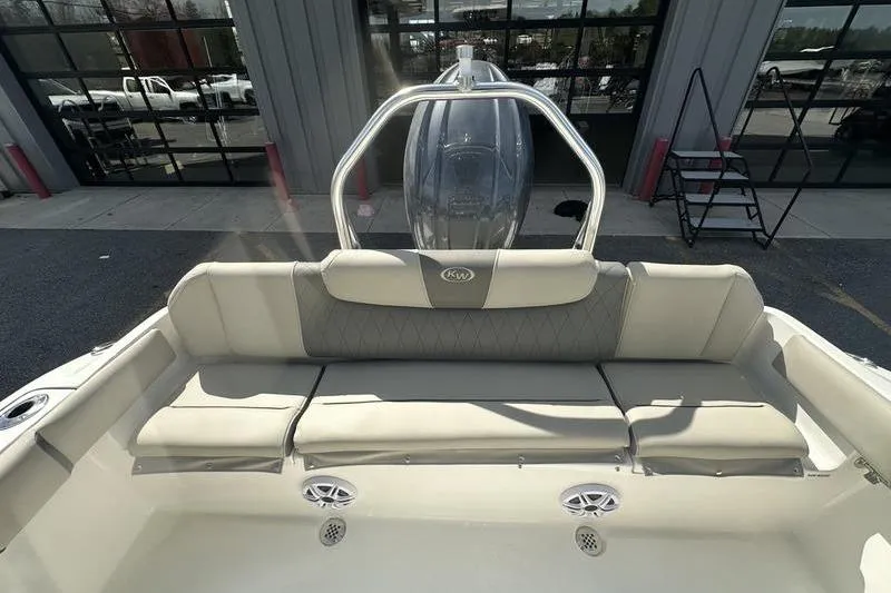 Slide: The Image of 2026 Key West 219 FS boat interior with cushioned seating and stainless steel details. - 8