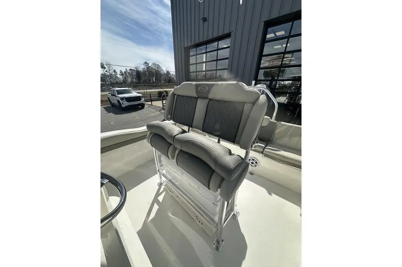 Slide: The Image of 2026 Key West 219 FS boat interior with cushioned seating and modern design. - 9
