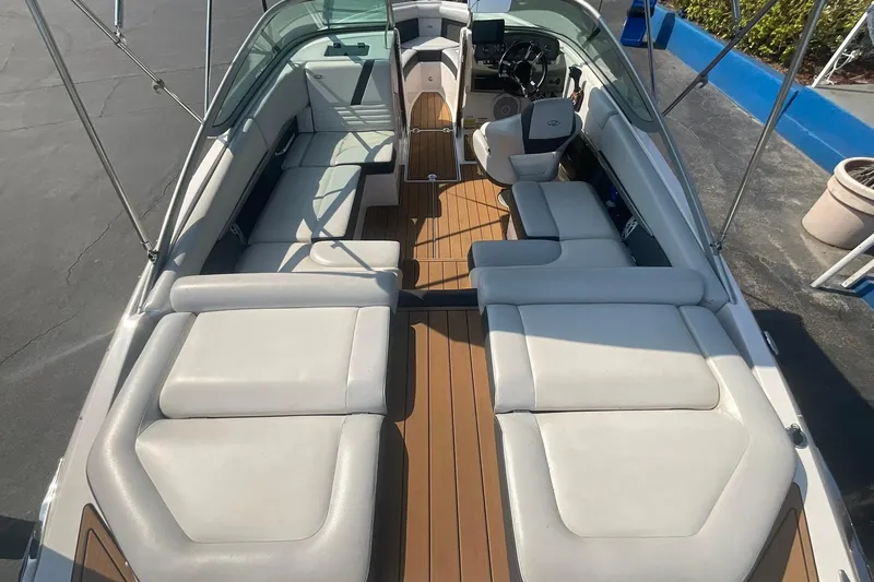 Slide: The Image of 2015 Regal 2100 Bowrider boat interior with spacious seating and sleek design. - 10