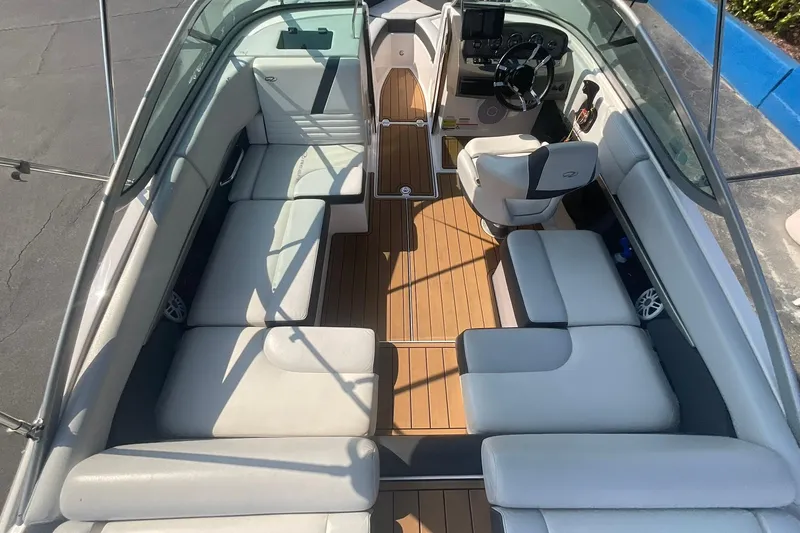 Slide: The Image of 2015 Regal 2100 Bowrider interior with spacious seating and modern dashboard. - 11